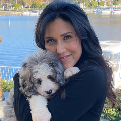 Alecia Yelich taking a picture with her pet dog.
